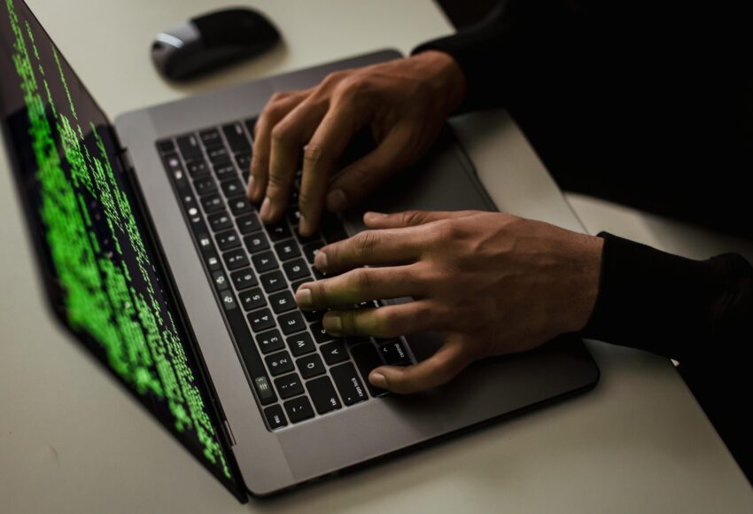 crop-cyber-spy-hacking-system-while-typing-on-laptop