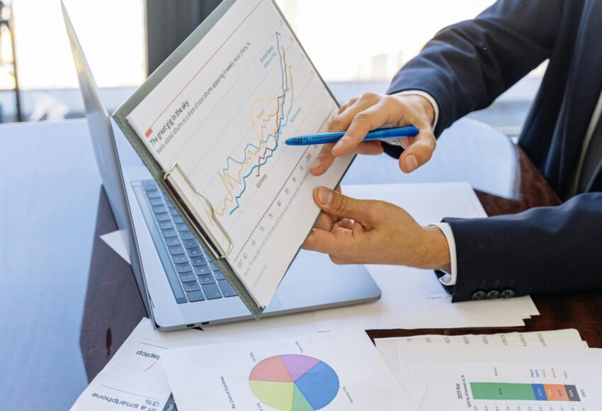Free Business professionals discussing financial graphs and charts in an office setting. Stock Photo